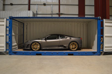 open sided container storing a grey ferrari
