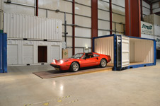 red ferrari loading into safe storage container